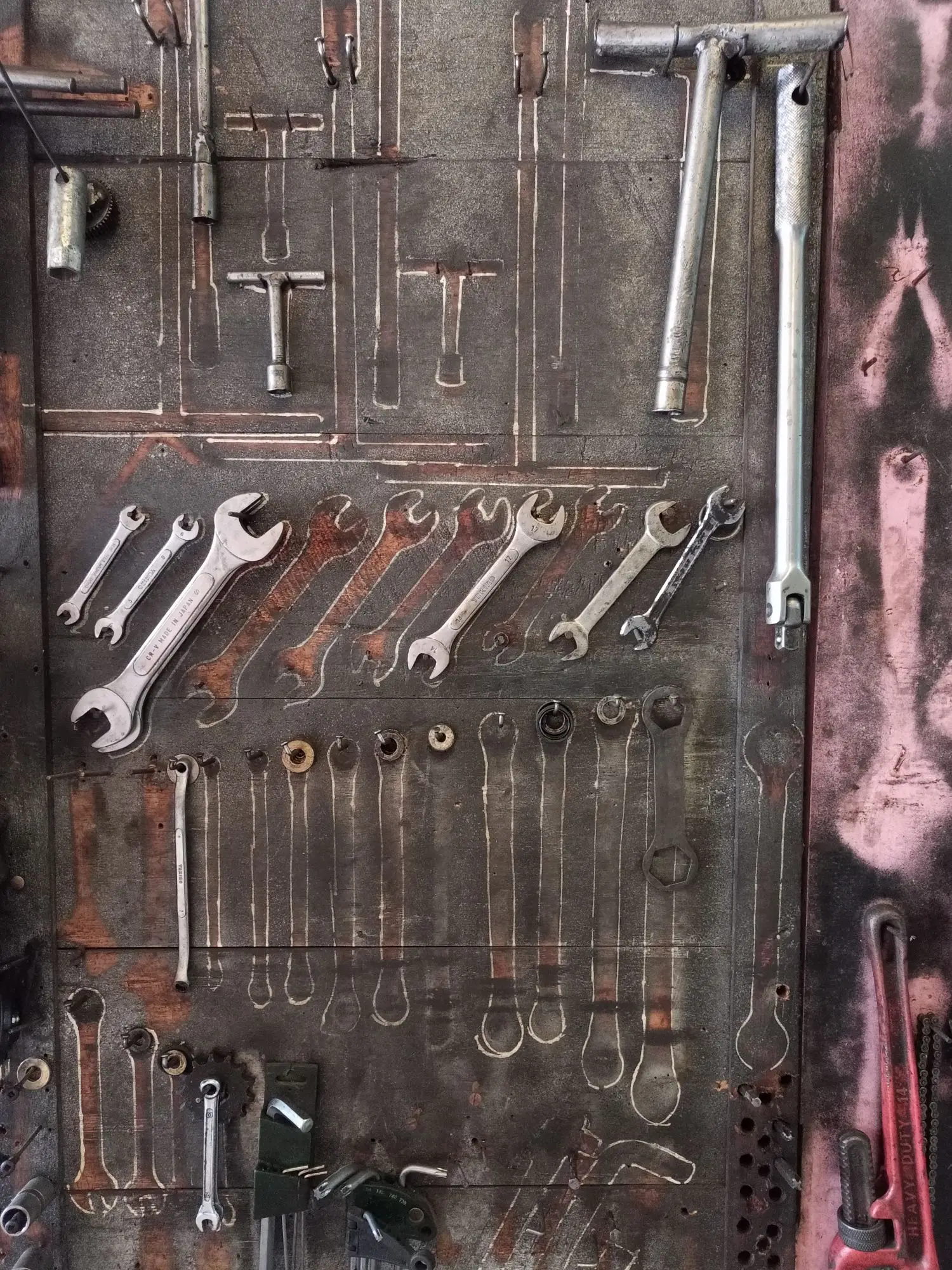 Organized bicycle hand tools on a workshop wall