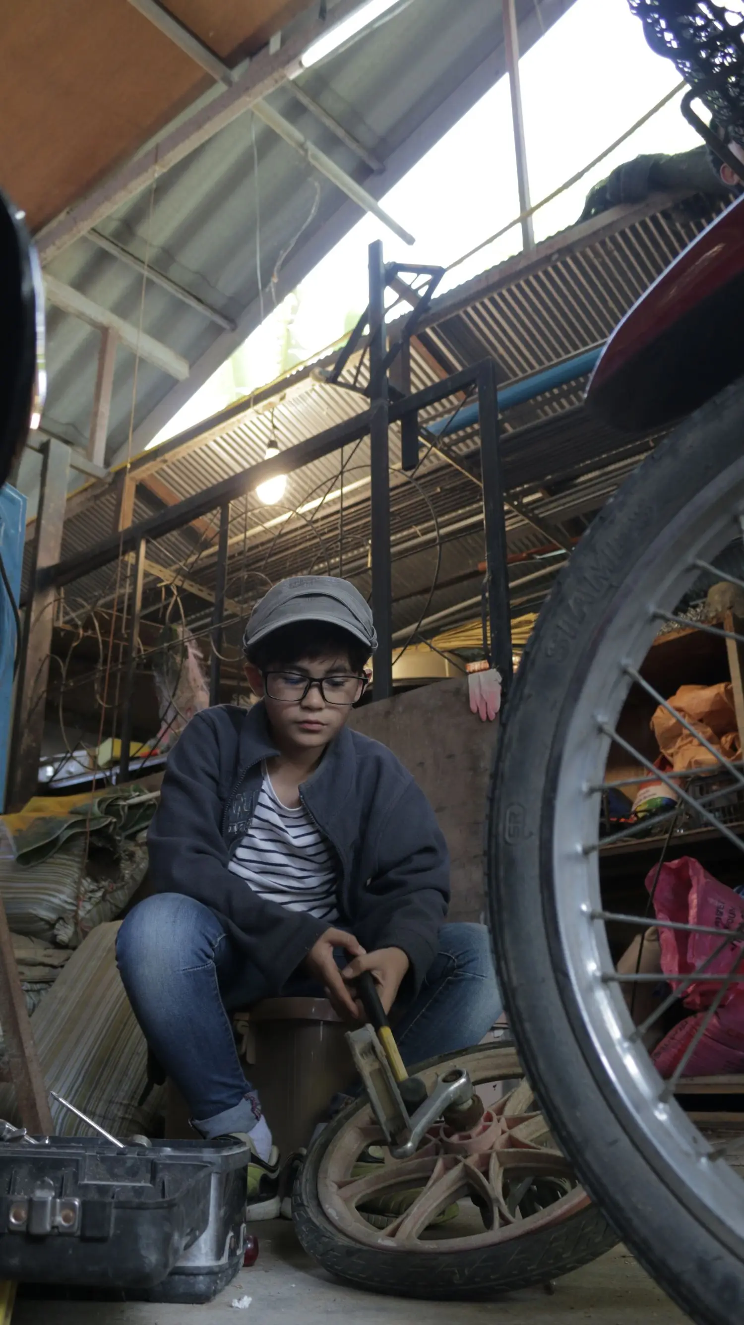 Bicycle mechanic working inside a workshop