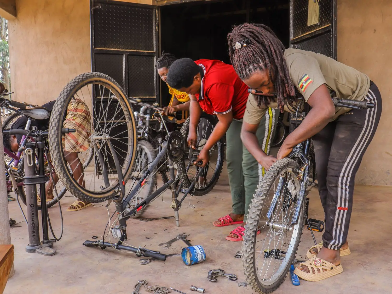 Two bicycle mechanics working on wheels together